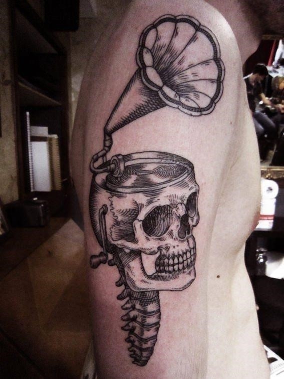 A human skull opens to reveal a gramophone in this vintage style tattoo by Otto D Ambra