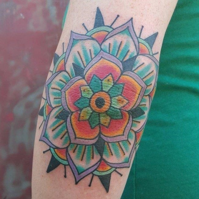 Floral style mandala tattoo on the left inner elbow.