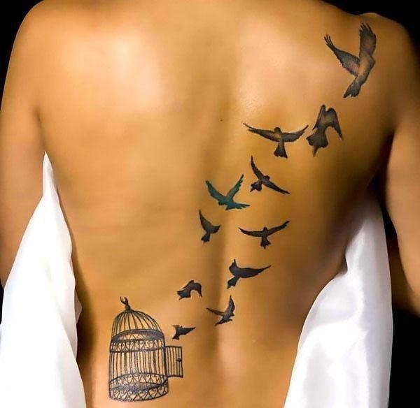 An awesome birdcage tattoo with free birds flying from it