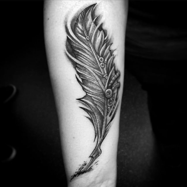 Awesome Black Ink Owl Feather Tattoo On Forearm