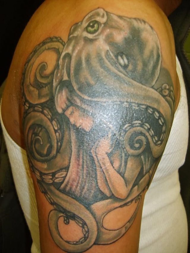 Black And Grey Octopus Caught Girl Sleeve Tattoo