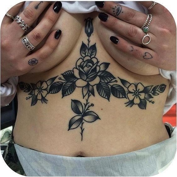 Black roses tattoo on the sternum