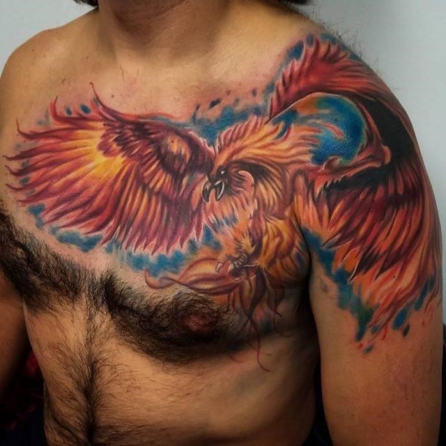 Flying Colored Phoenix Tattoo On Chest For Men