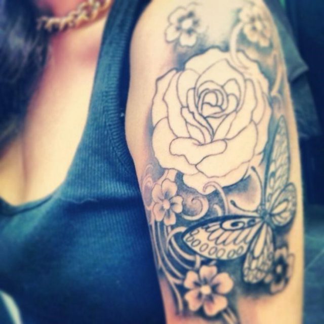 Grey Ink Feminine Flower With Butterfly Tattoo On Girl Left Half Sleeve