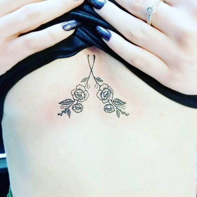 Small flowers sternum tattoo