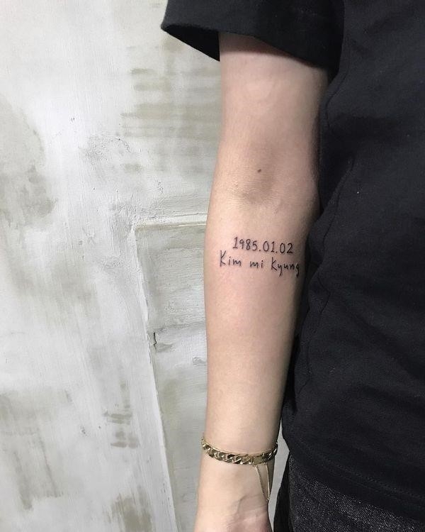 Small yet elegant name tattoo with date of birth