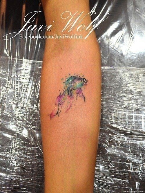 Splashes of color makes this watercolor tattoo of a goldfish by Javi Wolf an abstract masterpiece