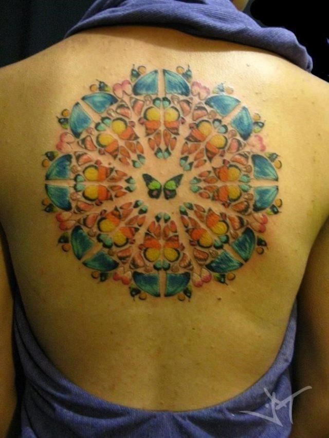 This colorful mandala tattoo uses butterfly wings to create the form of the sacred geometry symbolizing flight freedom spirituality and beauty