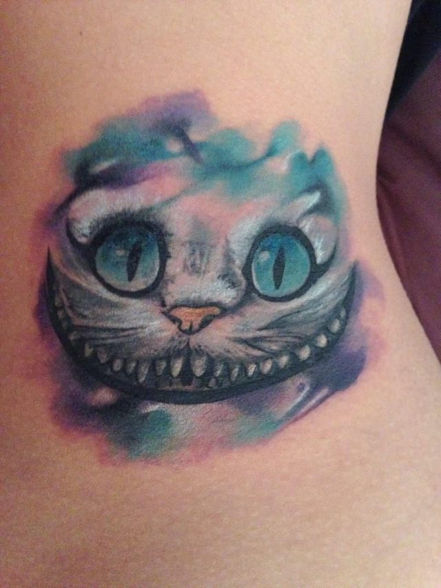 Watercolor Cheshire Cat Face Tattoo