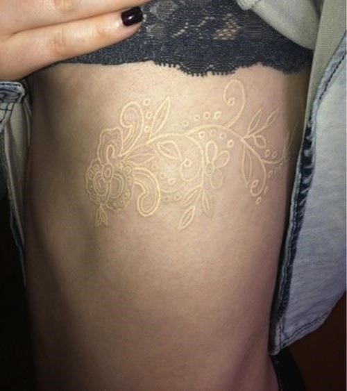 White Ink Flowers Tattoo On Girl Side Rib