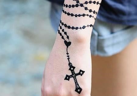 Woman wrist cross tattoo