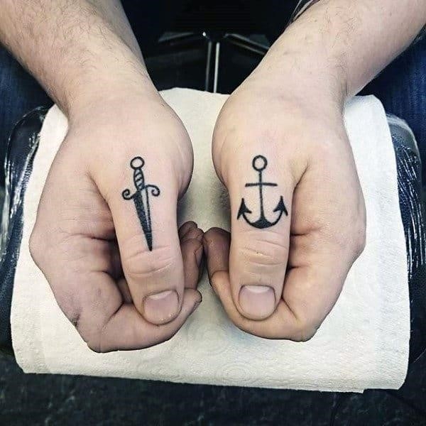Awesome knuckle tattoos for males sword and anchor
