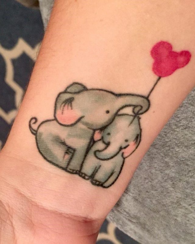 Baby Elephants With Micky Mouse Balloon Tattoo On Wrist