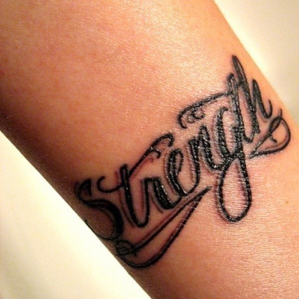 Black ink strength tattoo on arm