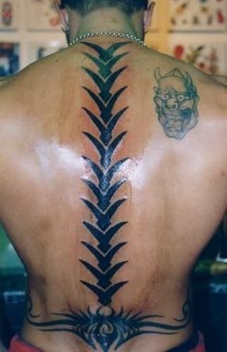 Black tribal spine tattoo