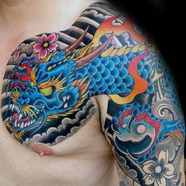 Blue flaming japanese dragon guys chest tattoo