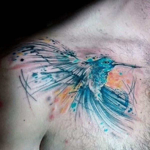Brush stroke guys hummingbird watercolor tattoo on upper chest with blue ink design