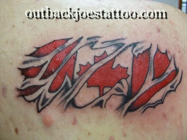 Canadian flag ripping through skin tattoo design