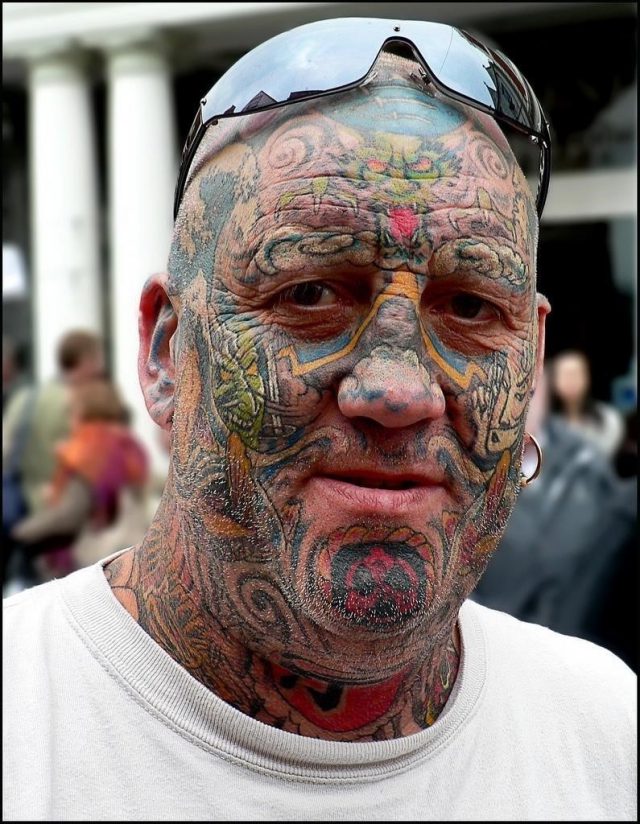 Colored crazy face tattoo