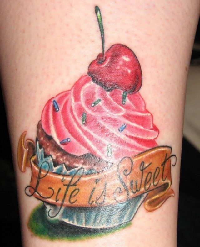 Colored ink cherry cupcake with life is sweet banner tattoo