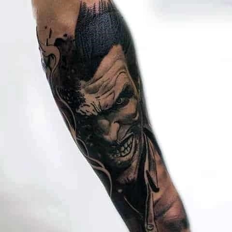 Cool manly guys joker sleeve tattoo with black and grey ink shaded design