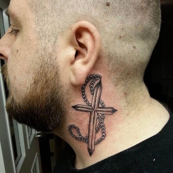 Cross neck tattoo