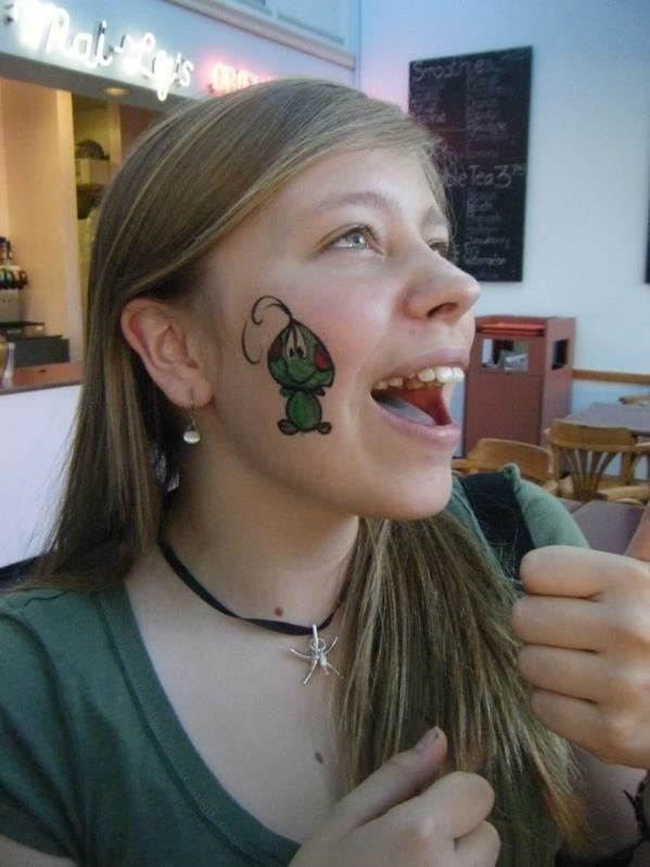 Free Photo  Young attractive caucasian female with tattoos standing in the  park and making a cute face