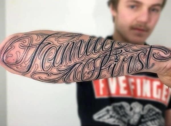 Devoted male with family first tattoo on forearms