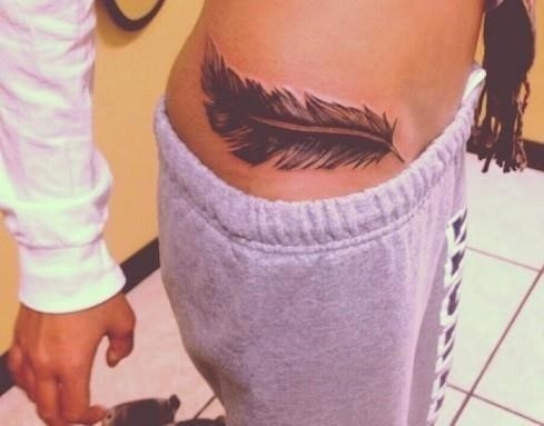 Feather hip tattoo