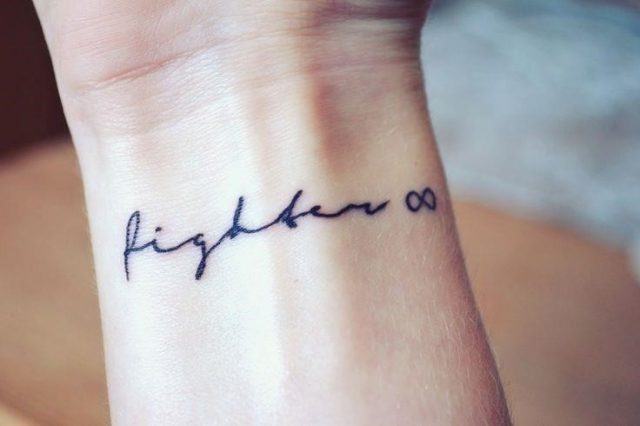 Fighter word wrist tattoo