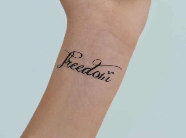 Freedom word wrist tattoo