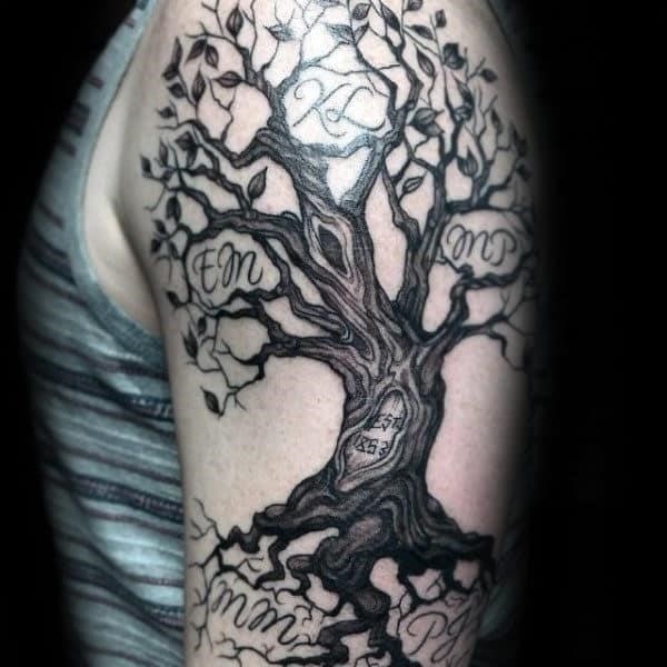 Gentleman with carved trunk family tree upper arm tattoo design