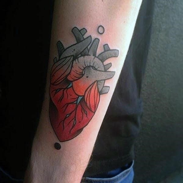 Gentleman with heart tattoo in neo traditional style on bicep
