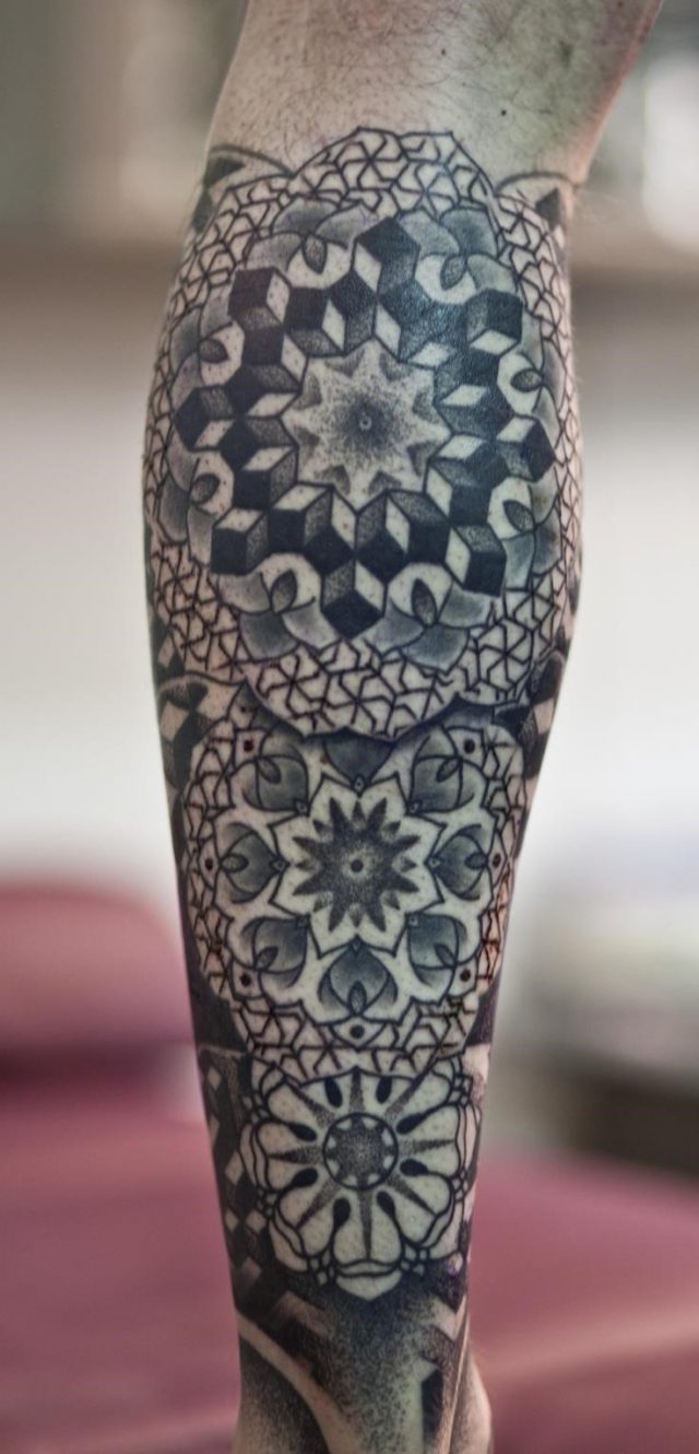 Grey ink geometric back leg tattoo
