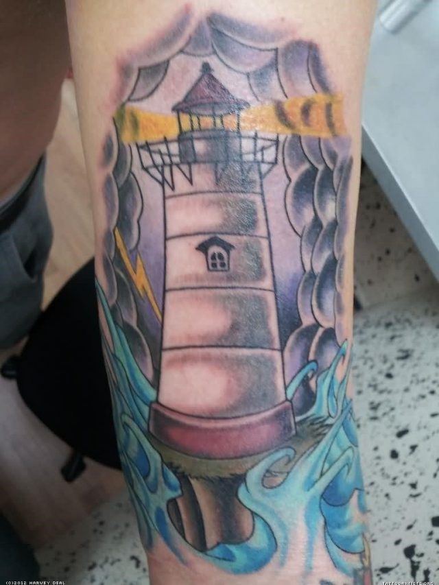 Grey ink lighthouse tattoo on leg sleeve