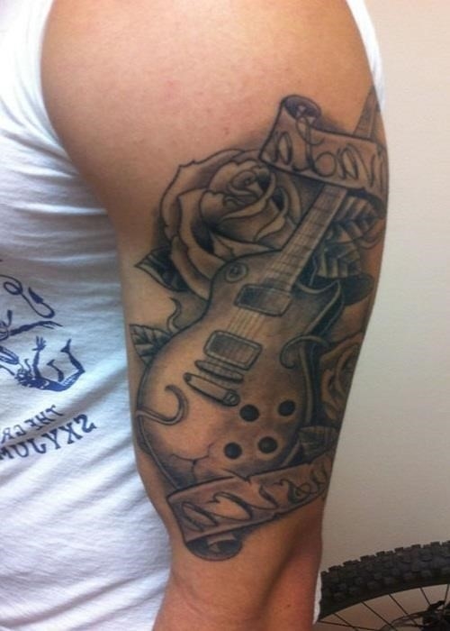 Grey ink rose flower and guitar tattoo on man left half sleeve
