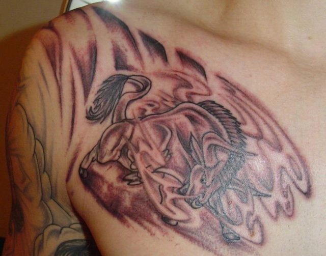 Grey ink taurus tattoo on man right colalrbone