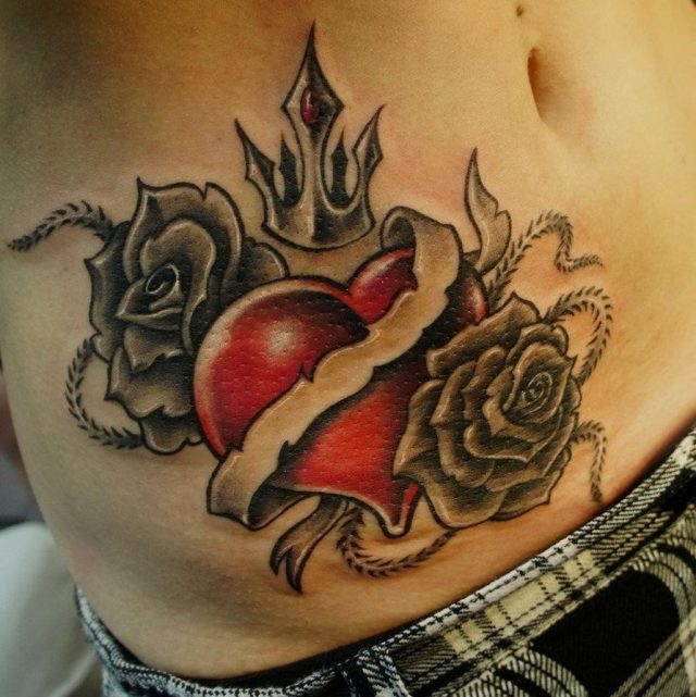 Grey rose flowers and red heart tattoo on hip