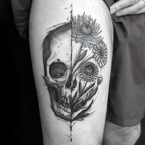 Guy with thigh tattoo of life death skull and flowers