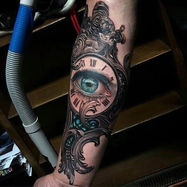 Guys forearms green eye inside clock sick tattoo