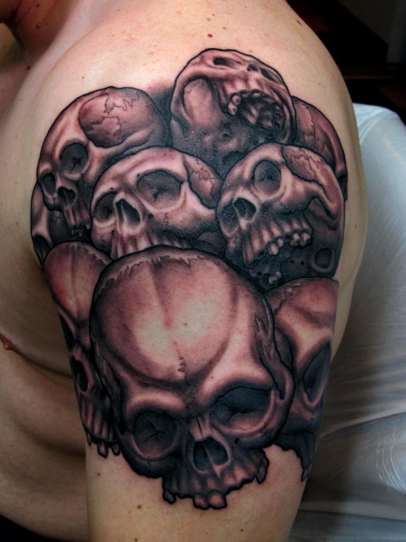 Black and Grey Stack Of Skull And Joker Theme Tattoo Idea  BlackInk