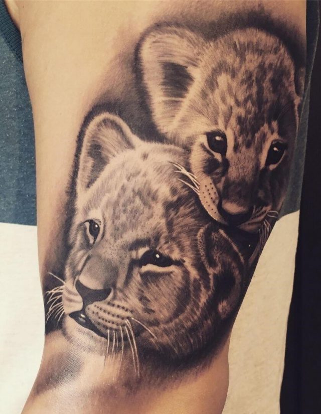 Lion cub tattoo arm