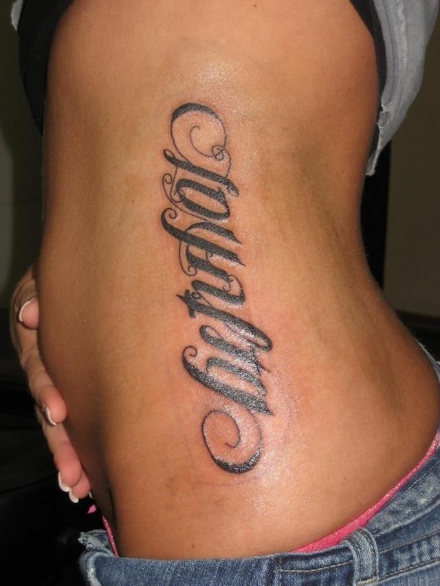 Loyalty ambigram tattoo on rib side