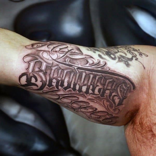 Male with brothers ornate word inner arm bicep tattoo design