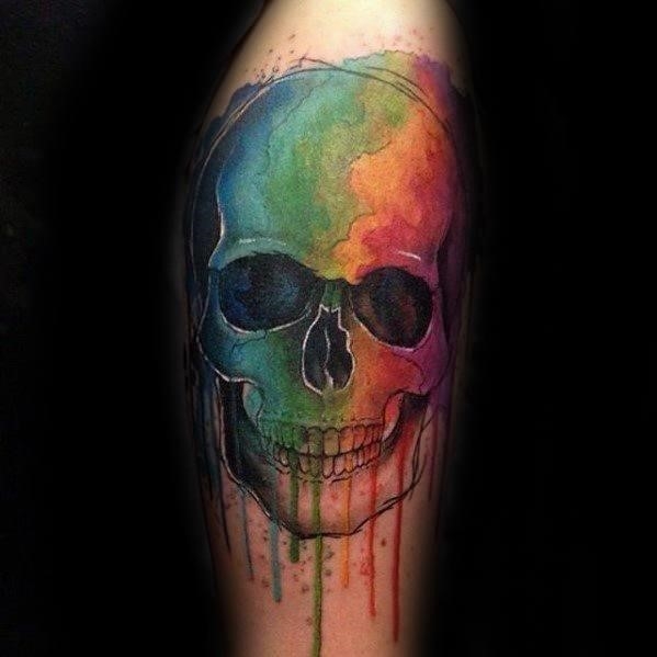 Male with cool watercolor skull tattoo design on arm