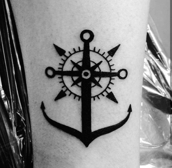 Male with simple anchor and compass tattoos