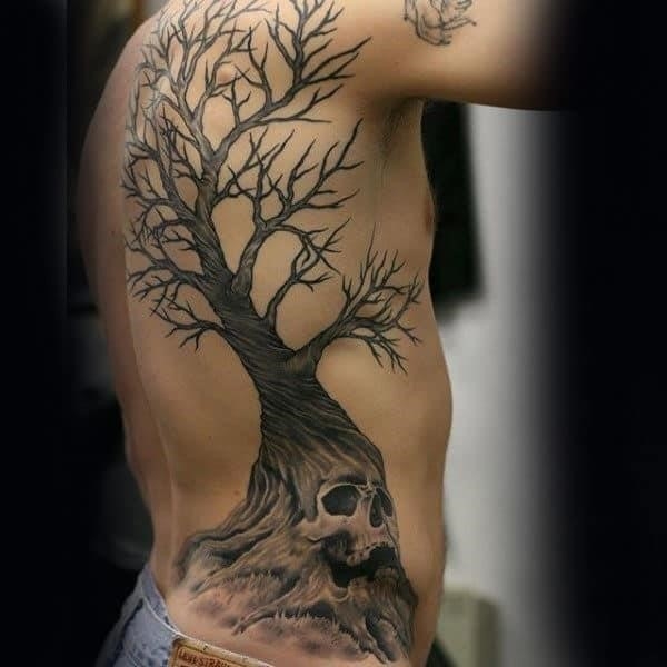 Man with skull tree rib cage side and back tattoos
