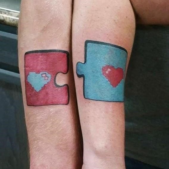 Matching his and hers puzzles tattoos