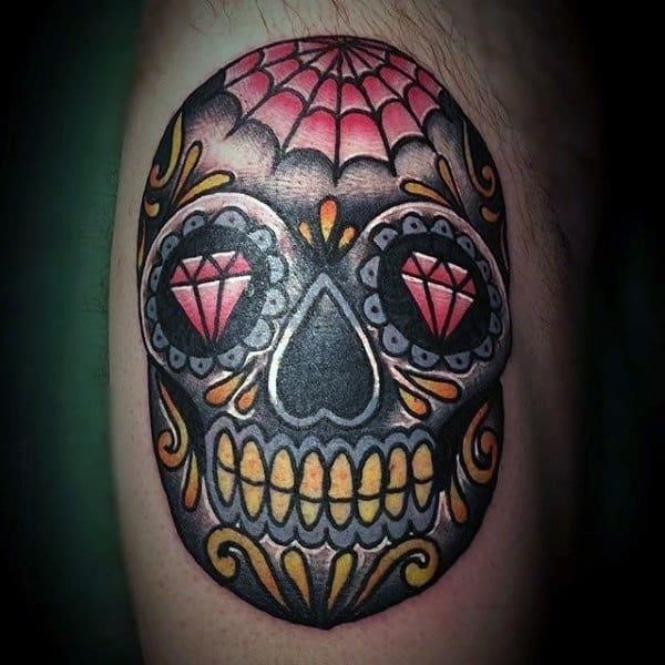 Mens black red and yellow ink sugar skull bicep tattoo