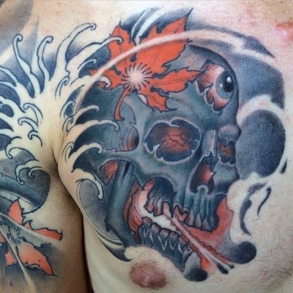 Mens chest tattoo of skull with japanese maple leaf